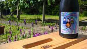 Fles Nieuw-Zeelands speciaalbier staat op een houten kratje in een zonnige buitenomgeving